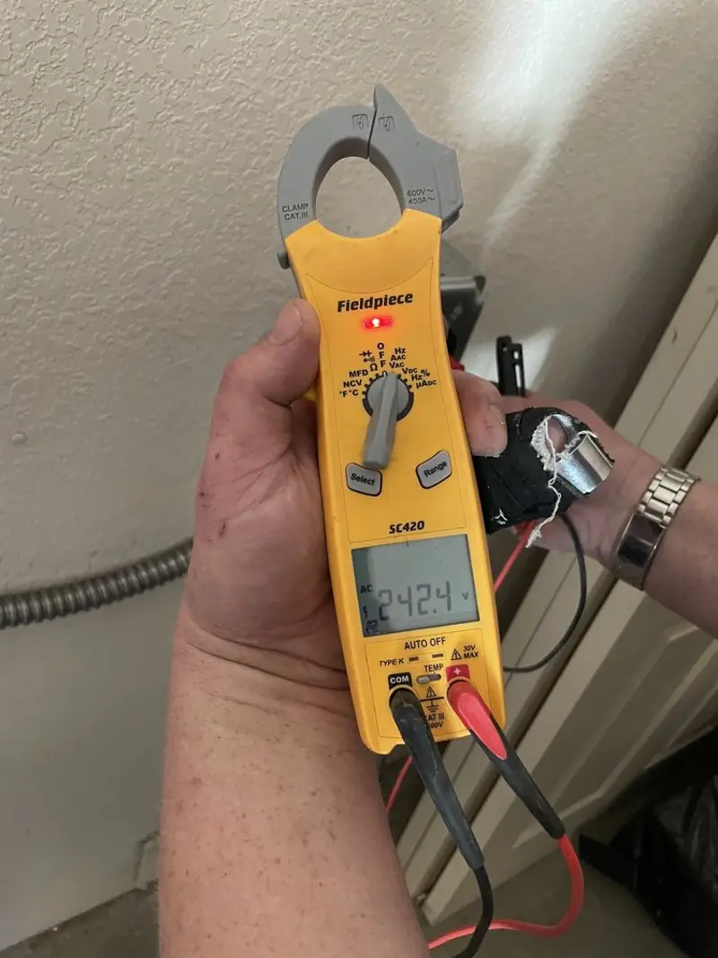 Voltage testing with clamp meter during Recessed Lighting Installation in Jeanerette